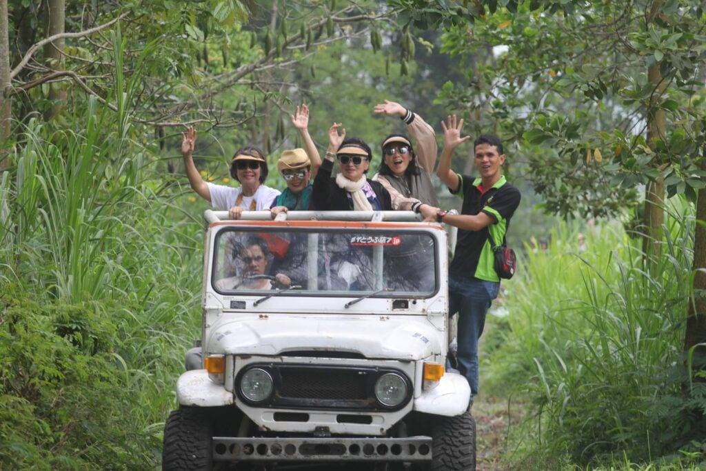 Kaliandra resort organic farm jeep off road waving people